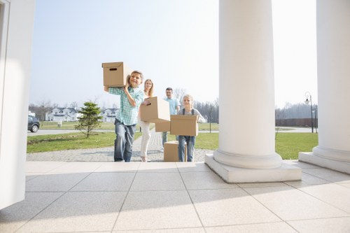 Movers carrying furniture during a Brixton flat removal