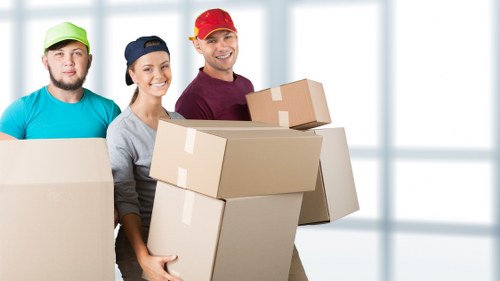 Moving boxes, furniture, and storage items prepared for a Brixton relocation