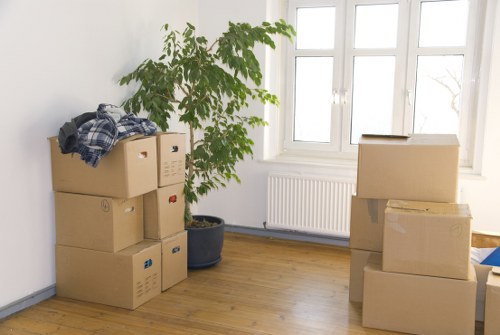 Professional movers carrying items through a Brixton flat staircase