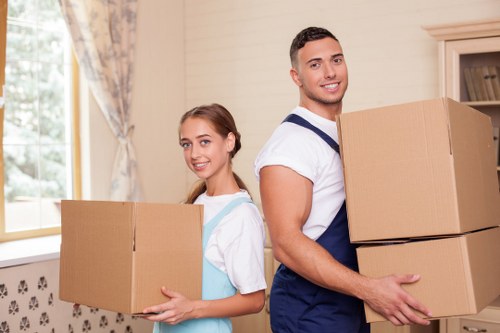 Brixton moving service handling boxes at a residential property