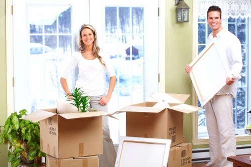 Packed furniture and household items being organised inside a removal van