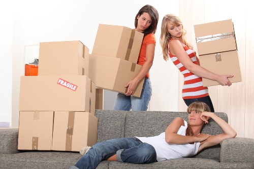 Boxes and furniture being loaded into a moving van in Brixton